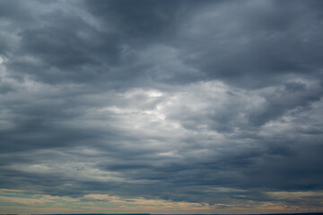 Cloudscape before rain background. Clouds pattern. Heavy hanging clouds high in the sky.