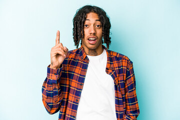 Young African American man isolated on blue background having an idea, inspiration concept.