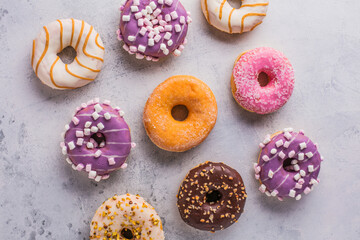 Tasty sweet donuts on a gray background