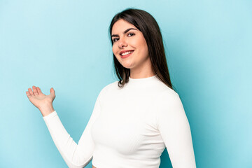 Young caucasian woman isolated on blue background showing a welcome expression.