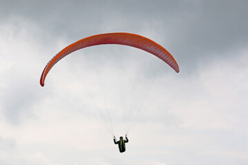 	
Paraglider in a cloudy sky	