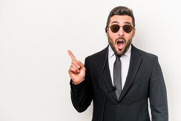 Young caucasian bodyguard man isolated on white background pointing to the side