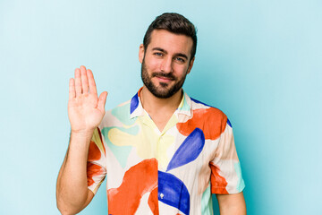 Young caucasian man isolated on blue background smiling cheerful showing number five with fingers.