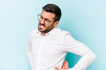 Young caucasian man isolated on blue background suffering a back pain.