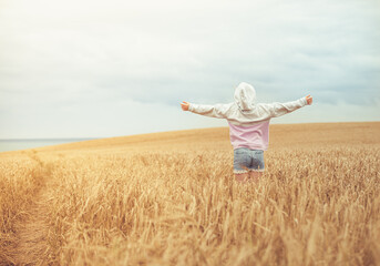 Naklejka na ściany i meble Happy girl in wheat field
