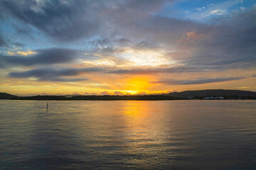 Sunrise waterscape with a mix of low, medium and high clouds