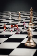 Construction and chess pieces on a chessboard against neutral endless background. Chess as a symbol of strategy, intelligence, power and business. Dark mood.