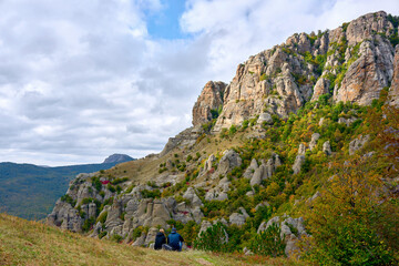 View of the mountains of the valley of ghosts. Tourists look at the mountains. Crimea, South Demerdzhi.