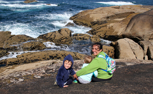 madre con dos ni&ntilde;os miran el oceano atlantico en finisterre. Muxia, camino de santiago