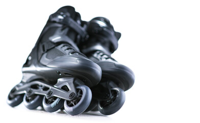 A pair of black inline skates isolated on white background