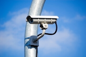 Fototapeta premium City monitoring system camera against blue sky.