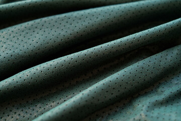 Green genuine leather background, perforated fabric, close-up