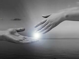 Inspirational quote concept. With helping hands touch the light, reaching out each other.