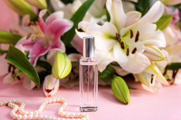 Bottle of perfume and pearl neck chain with flowers on color background