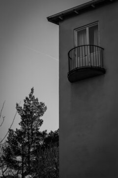 A funny looking balcony on a residential building. Photo in B/W. 
