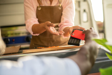 Crop man making payment for order in food truck
