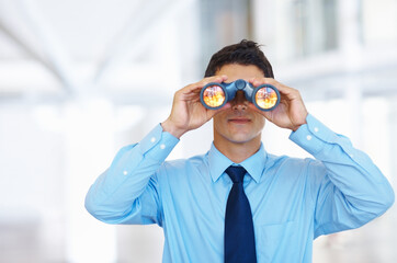 Business vision. Portrait of young business man seeking through binoculars.