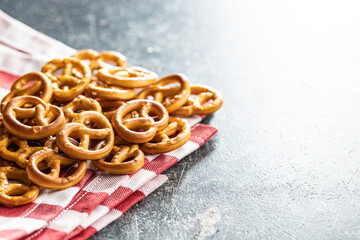 Mini pretzels. Crusty salted snack on kitchen table.