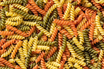 Three colors fusilli pasta. Colorful italian raw pasta.