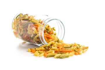 Three colors fusilli pasta in jar. Colorful italian raw pasta isolated on white background.