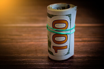 dollars twisted on wooden background