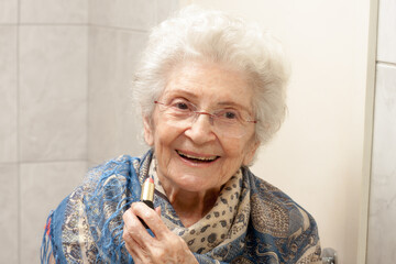 Elderly Lady Applying Lipstick in front of a Mirror