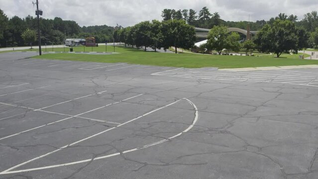 Drone fly over parking lot rise up to to reveal city hall amphitheater