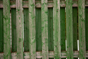 old wooden green fence with peeling paint