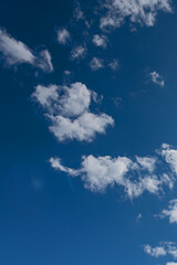 white cumulus clouds on blue sky as natural background