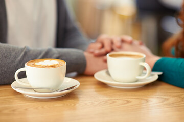 Sweet coffee and sweet nothings. A cropped shot of a young affectionate couple on a coffee date.