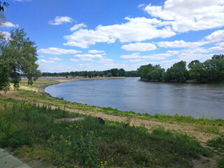 Beautiful natural scenery of river. Panoramic view of valley of river lake. Peaceful summer landscape with green hills, beautiful woods, meadows, river curves and fields. Spring forest river flow land