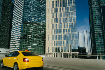 Taxi car are driving near downtown. Moscow City, business center