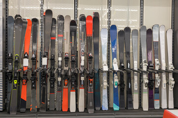downhill skis on the shelves of a sports equipment store