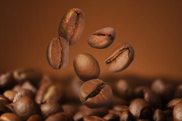 Fototapeta premium Falling aromatic roasted coffee beans, closeup view
