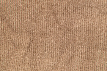 fabric grunge background, real cotton denim brown, wrinkled, frayed, close