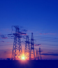  high-voltage  power lines at sunset.