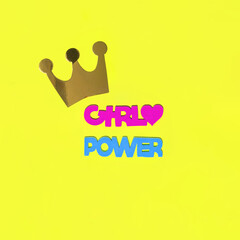 Creative pop art Women's Day idea. Girl power letters and crown on yellow background. Modern March 8 concept. Minimal feminist flat lay composition.
