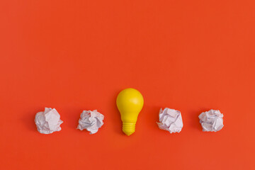 Paper and light bulb on yellow background. Idea concept