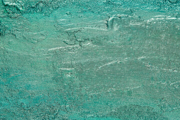 abstract background: textured plaster with emerald turquoise color, close