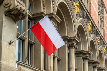 Flag of Poland on the facade of an old government building