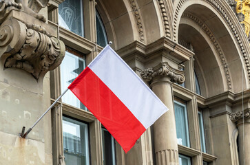 Flag of Poland on the facade of an old government building