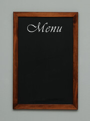 Black chalkboard with word Menu on light grey background. Mockup for design