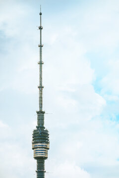 Ostankino television tower in Moscow against white clouds and blue sky