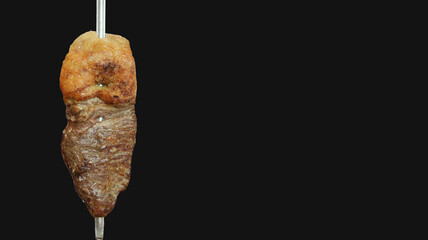 Fraldinha. Traditional brazilian meat grilled in black background.