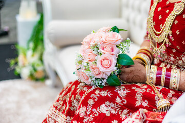 Indian bride's holding wedding flowers hands close up