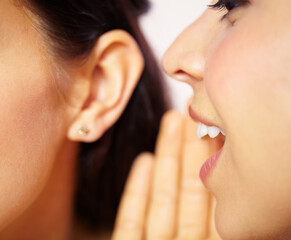 I have something to tell you. Cropped view of a young woman telling a secret to a friend. - obrazy, fototapety, plakaty