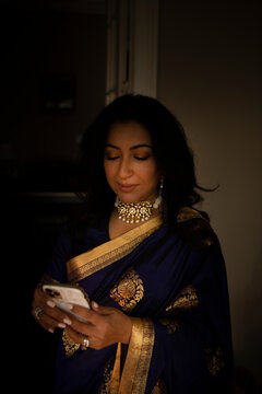 Woman in a sari texting 