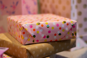 Pink gift wrapped presents in bags and packages ready for a birthday celebration.