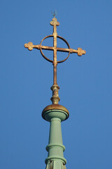 Cross with a circle on top of the church on the blue sky backgroung