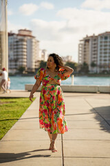 Attractive woman walking towards camera and glancing away